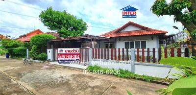 Exterior view of a house for sale with a front yard and fence