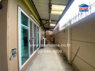 Covered outdoor walkway with sliding glass doors