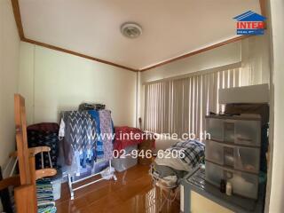 Bedroom with laundry and storage items