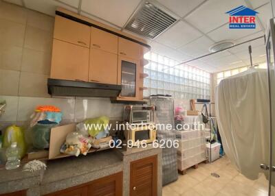 Kitchen with cabinets, countertop, and storage containers