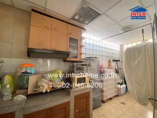 Kitchen with cabinets, countertop, and storage containers