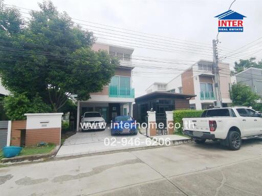 Two-storey residential houses with driveways and vehicles