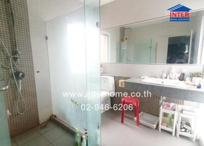 Modern bathroom with glass shower, sink, and mirror