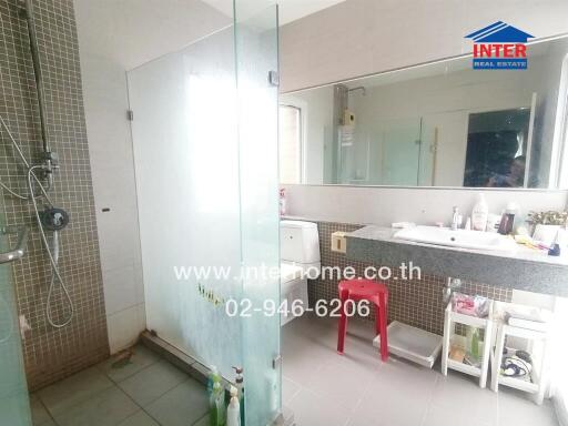 Modern bathroom with glass shower, sink, and mirror