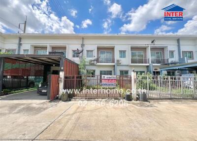 Front view of a townhouse with a gated entrance