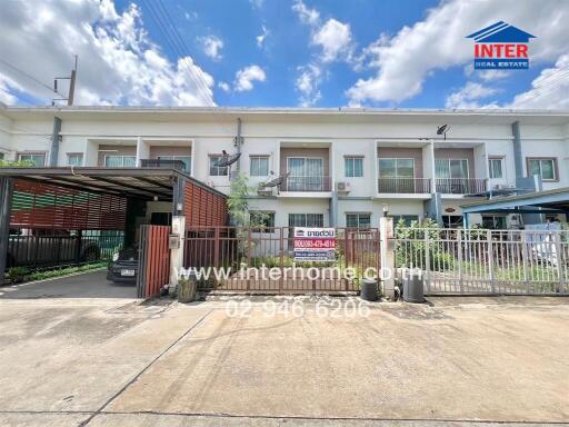 Front view of a townhouse with a gated entrance