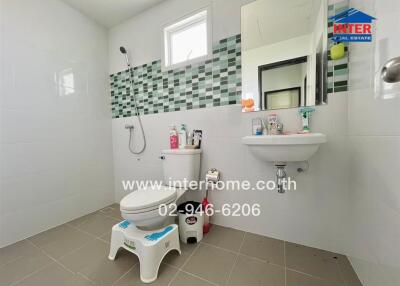 Modern bathroom with shower, sink, and toilet