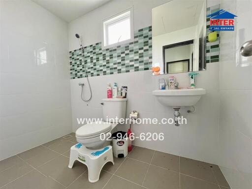 Modern bathroom with shower, sink, and toilet