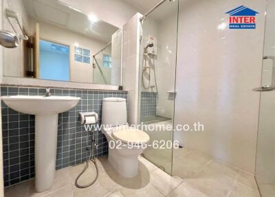 Modern bathroom with glass shower enclosure and tiled walls