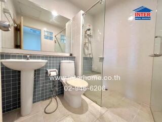 Modern bathroom with glass shower enclosure and tiled walls