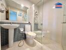 Modern bathroom with glass shower enclosure and tiled walls