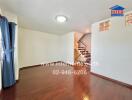 Spacious living area with wooden flooring and staircase