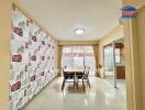 Bright dining area with large windows and patterned wall