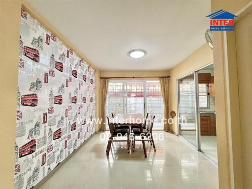 Bright dining area with large windows and patterned wall