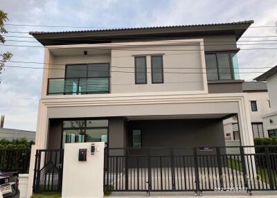 Modern two-story house with a gated entrance