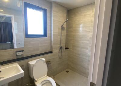 Modern bathroom with shower, sink, and toilet