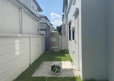 Side yard with grass and a concrete path