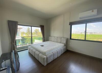 Modern bedroom with large windows