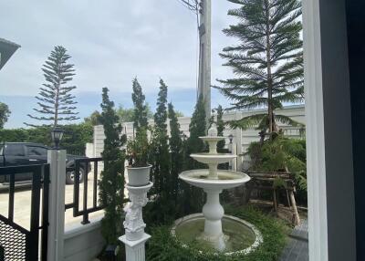 Outdoor garden area with fountain and plants