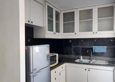 Modern kitchen with white cabinets and stainless steel appliances