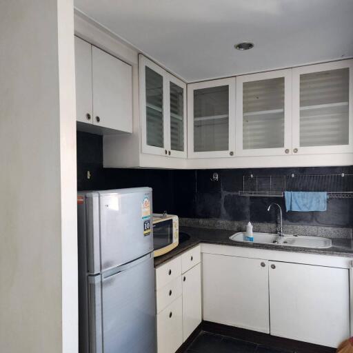 Modern kitchen with white cabinets and stainless steel appliances