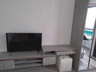 Minimalist living room with TV and storage units