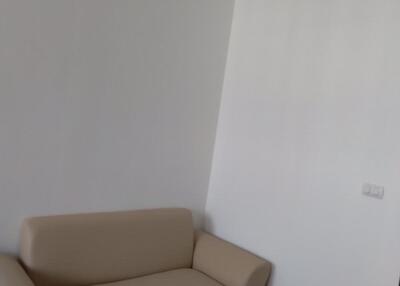 Living room with beige sofa and wall-mounted air conditioner