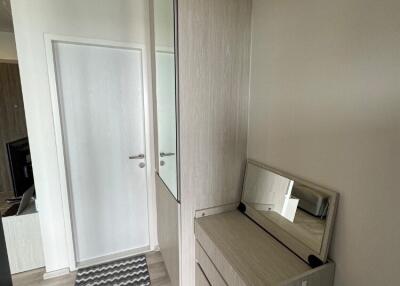 Hallway with storage cabinets and mirror