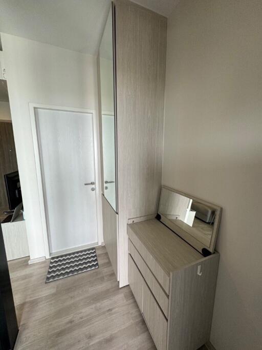 Hallway with storage cabinets and mirror