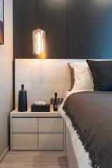 Modern bedroom with bedside table and lighting