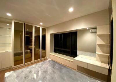 Spacious bedroom with mirrored wardrobe and built-in shelves