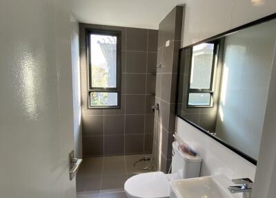 Modern bathroom with grey tiles and large mirror