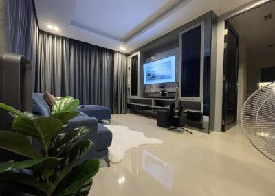 Modern living room with TV and blue sofa