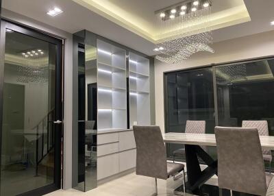 Modern dining room with glass doors and chandelier