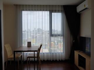 Living room with large window and city view