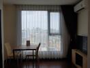 Living room with large window and city view