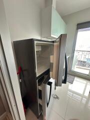 Modern kitchen with refrigerator and balcony access