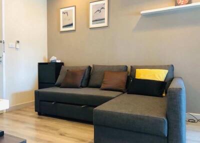 Modern living room with grey sectional sofa and decorative items