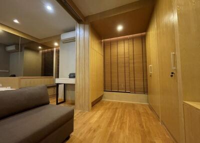 Modern living area with wooden flooring and built-in storage