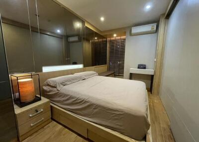 Modern bedroom with mirrored wardrobe and air conditioning