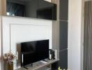 Living room with modern entertainment unit and air conditioner