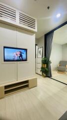 Modern living room with TV and ample lighting