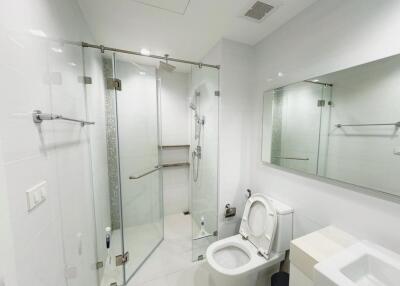 Modern bathroom with a glass-enclosed shower and toilet