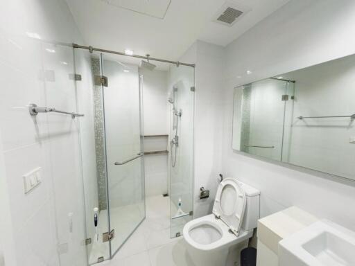 Modern bathroom with a glass-enclosed shower and toilet