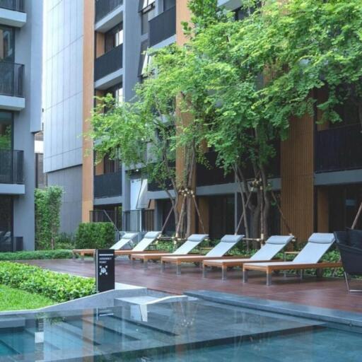 Apartment complex with outdoor pool and lounging area