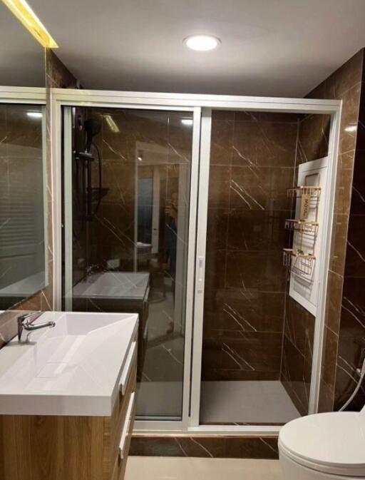 Modern bathroom with glass shower door and vanity