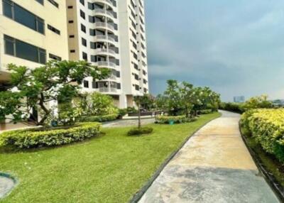 Exterior view of an apartment building with landscaped garden