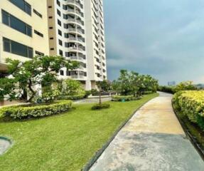 Exterior view of an apartment building with landscaped garden