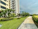 Exterior view of an apartment building with landscaped garden