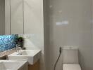 Modern bathroom with double sink and toilet